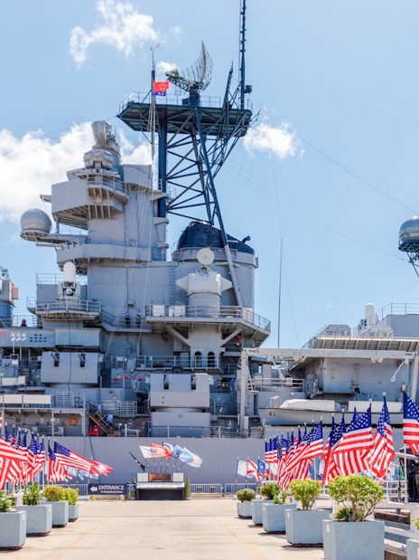 American flags line the walkway to the USS Missouri battleship at Pearl Harbor.