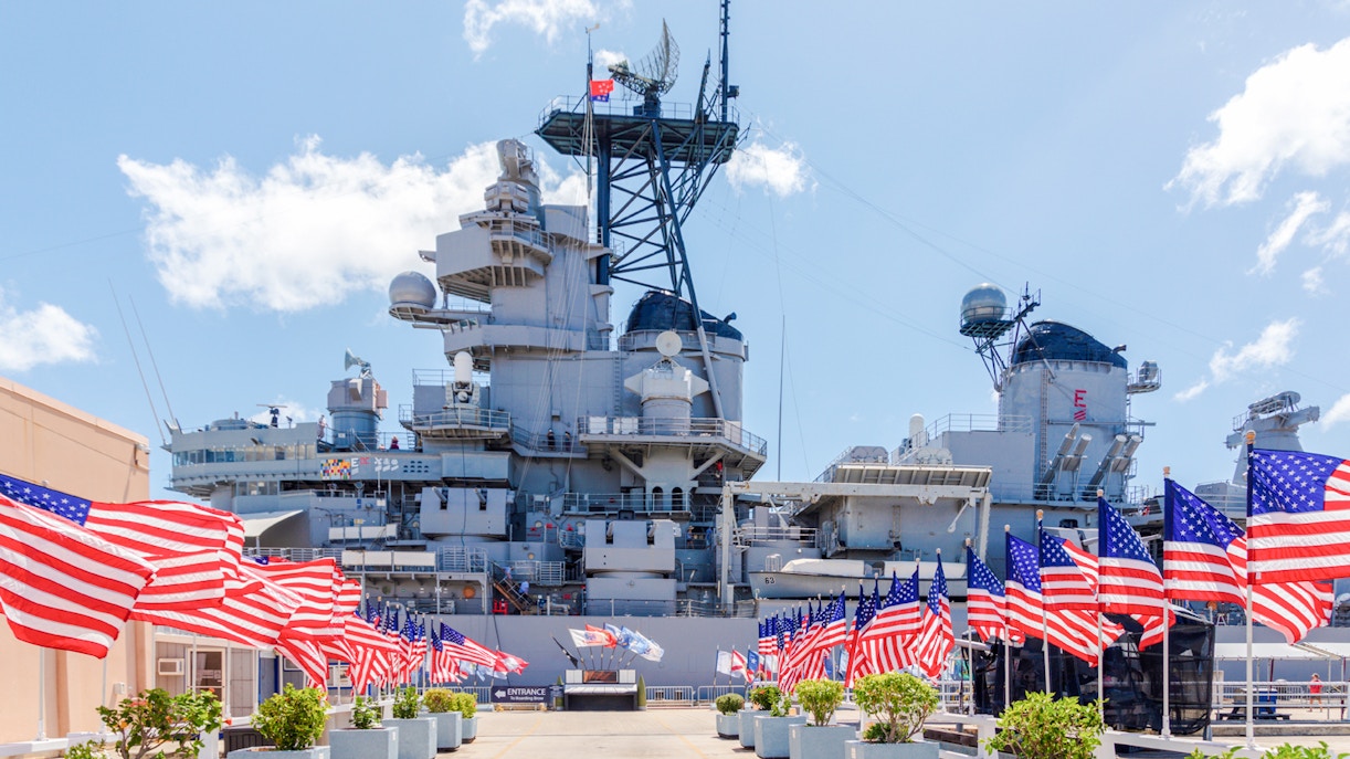 American flags line the walkway to the USS Missouri battleship at Pearl Harbor.