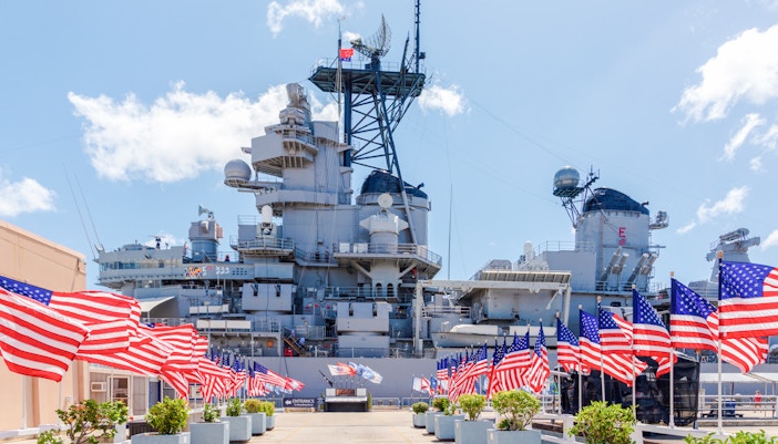 American flags line the walkway to the USS Missouri battleship at Pearl Harbor.
