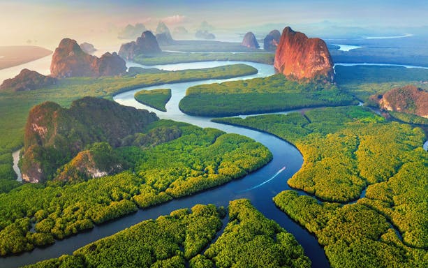 Aerial view of Phang Nga Bay with winding waterways and lush islands, Thailand.