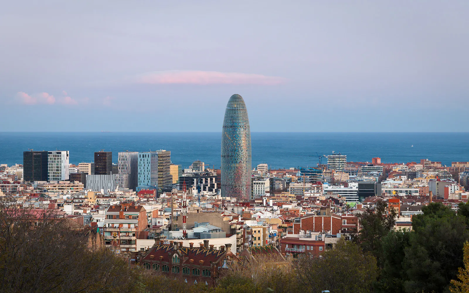 Skyline view of Barcelona with Torre Glòries and the Mediterranean Sea.