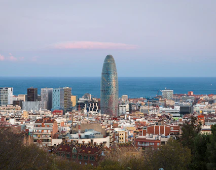 Skyline view of Barcelona with Torre Glòries and the Mediterranean Sea.