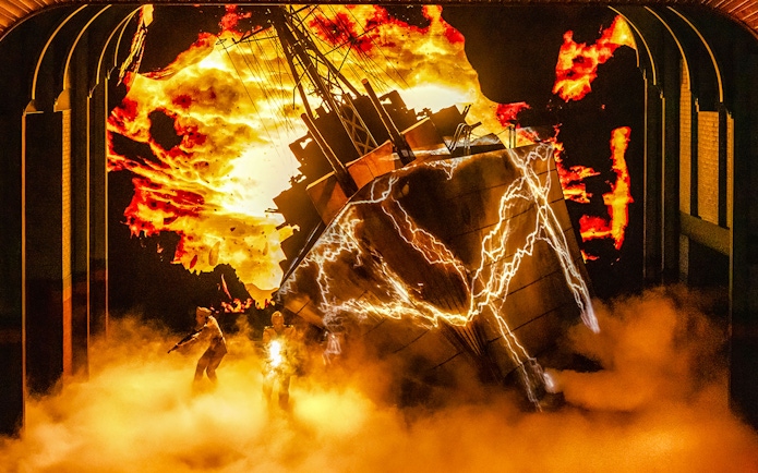 Stage scene with fiery background and lightning effects from Stranger Things experience.