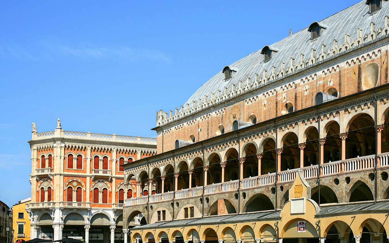 Ragione Palace exterior with arches and detailed facade in Padua, Italy.