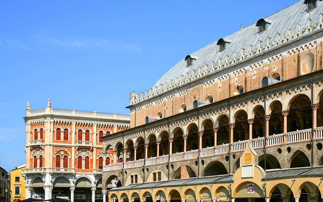 Ragione Palace exterior with arches and detailed facade in Padua, Italy.