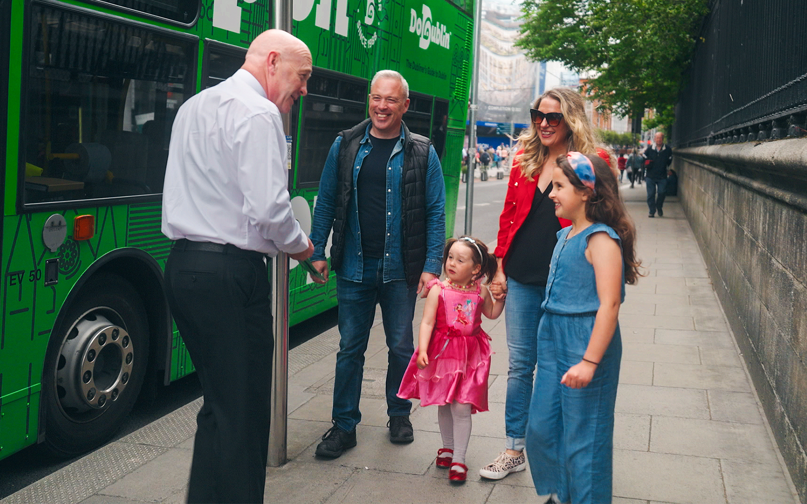 Family boarding Dublin hop-on hop-off bus with guide.