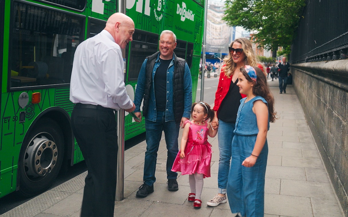Family boarding Dublin hop-on hop-off bus with guide.
