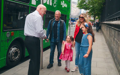 Family boarding Dublin hop-on hop-off bus with guide.