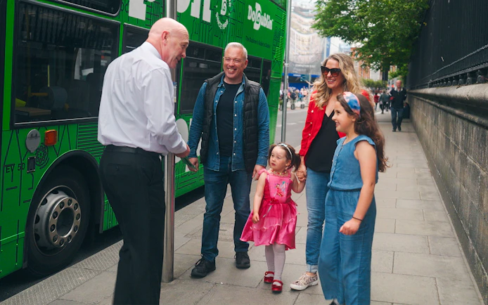 Family boarding Dublin hop-on hop-off bus with guide.