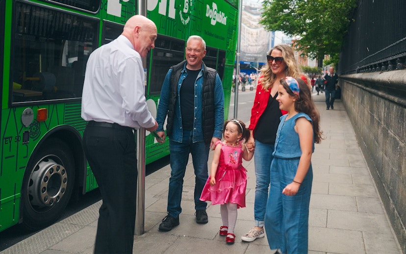 Family boarding Dublin hop-on hop-off bus with guide.