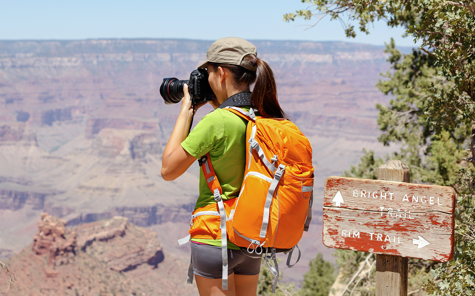 Hiker photographing Grand Canyon from Bright Angel Trail.