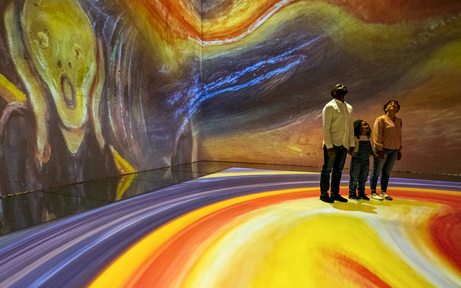 Visitors in Beyond Reality gallery at Frameless London with immersive art projections.
