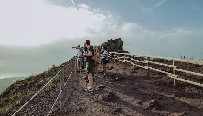 Visitors exploring the summit of Mount Vesuvius, Italy.