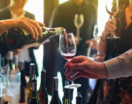 Pouring red wine into a glass