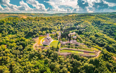Aerial view of Bodbe Monastery surrounded by lush greenery near Sighnaghi, Kakheti.