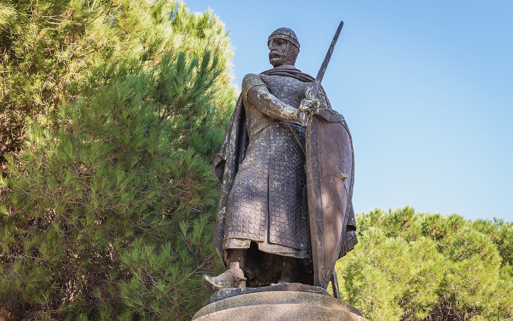 Statue of a medieval knight with sword and shield at St. George Castle, Lisbon.