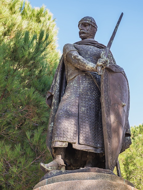 Statue of a medieval knight with sword and shield at St. George Castle, Lisbon.