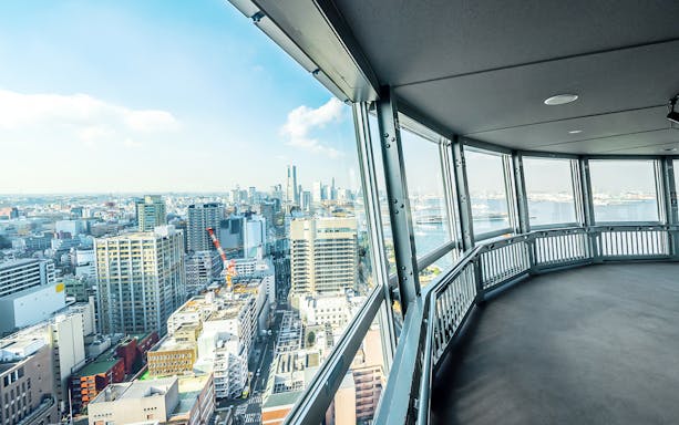 View from Yokohama Marine Tower overlooking cityscape and harbor in Yokohama, Japan.