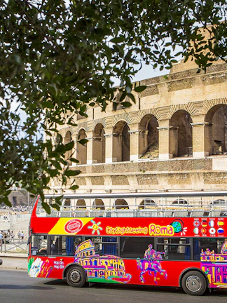 Sightseeing bus in front of the Colosseum, Rome.