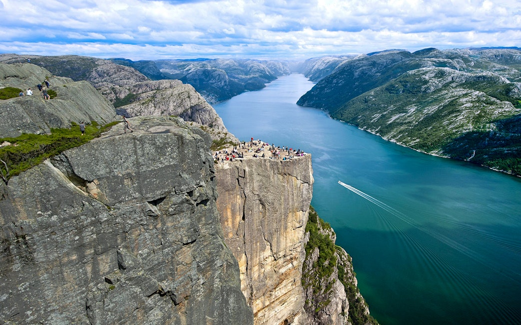 Aerial view of Preikestolen with tourists overlooking the Lysefjord in Norway.