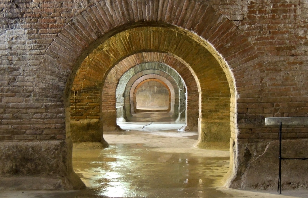 Roman aqueduct tunnels beneath Naples showcasing ancient engineering marvels.