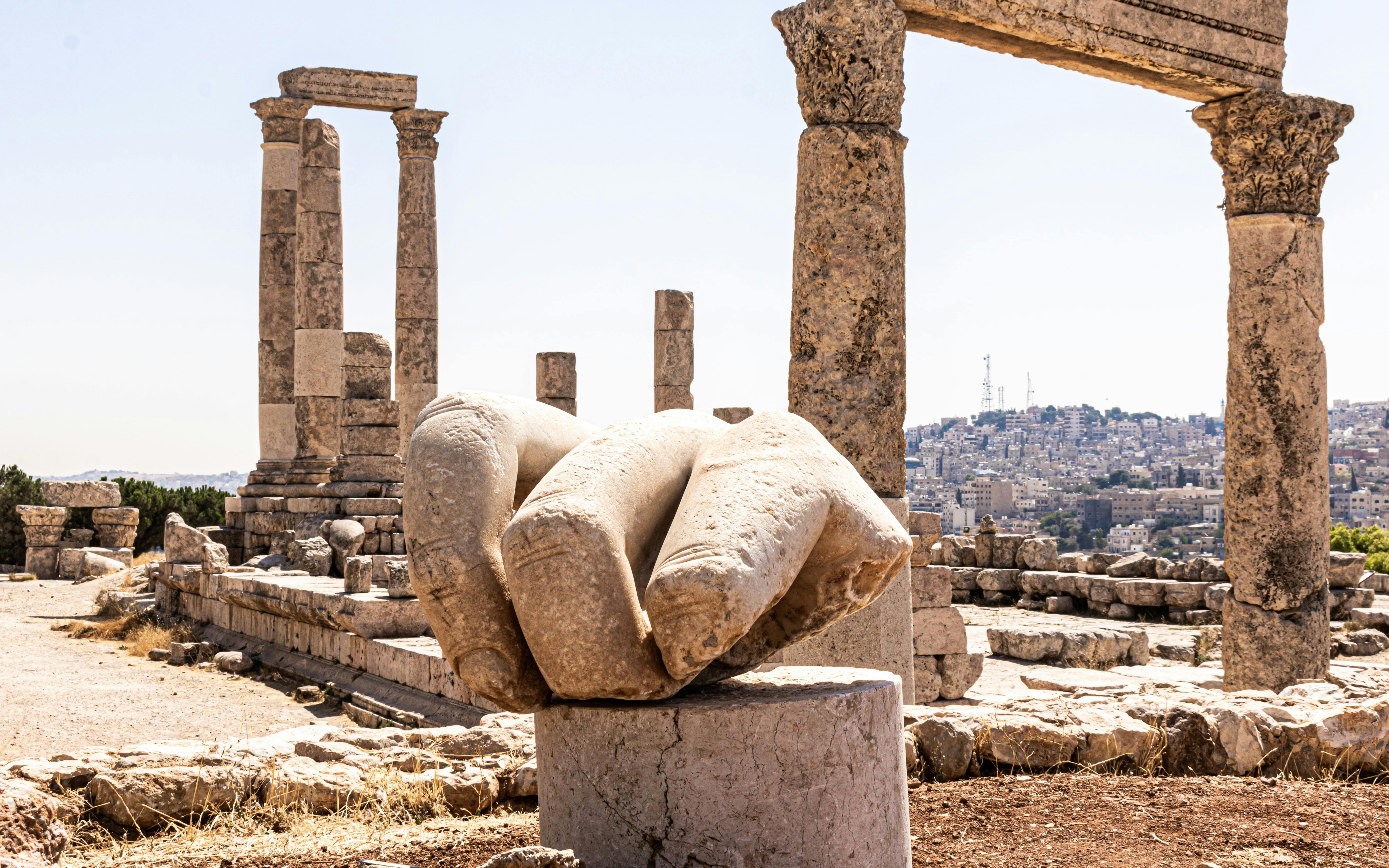 Temple of Hercules ruins with giant hand sculpture at Amman Citadel, Jordan.