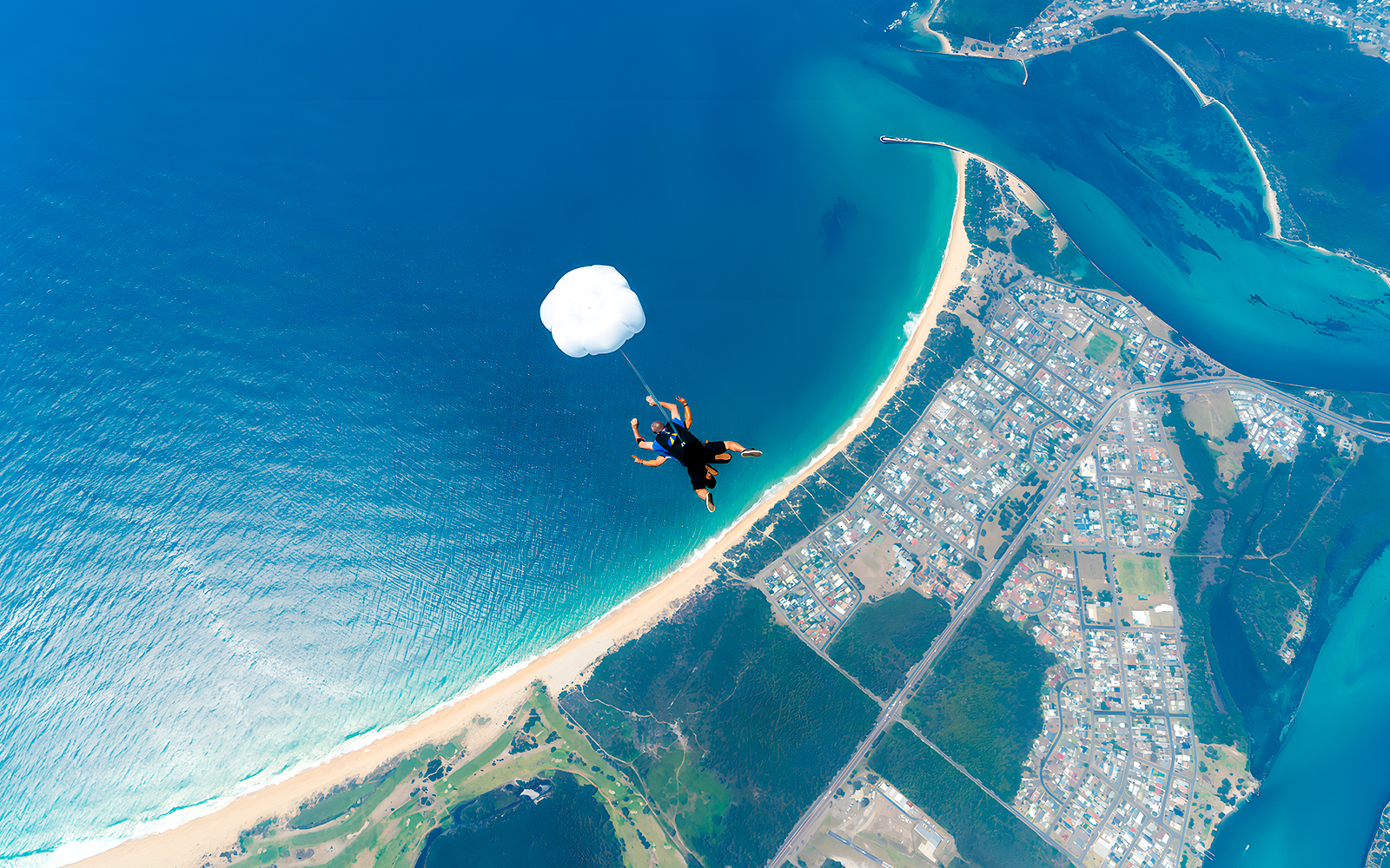A tourist skydiving over Newcastle, Australia