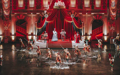 Performers in historical costumes during a show at Puy du Fou, France.