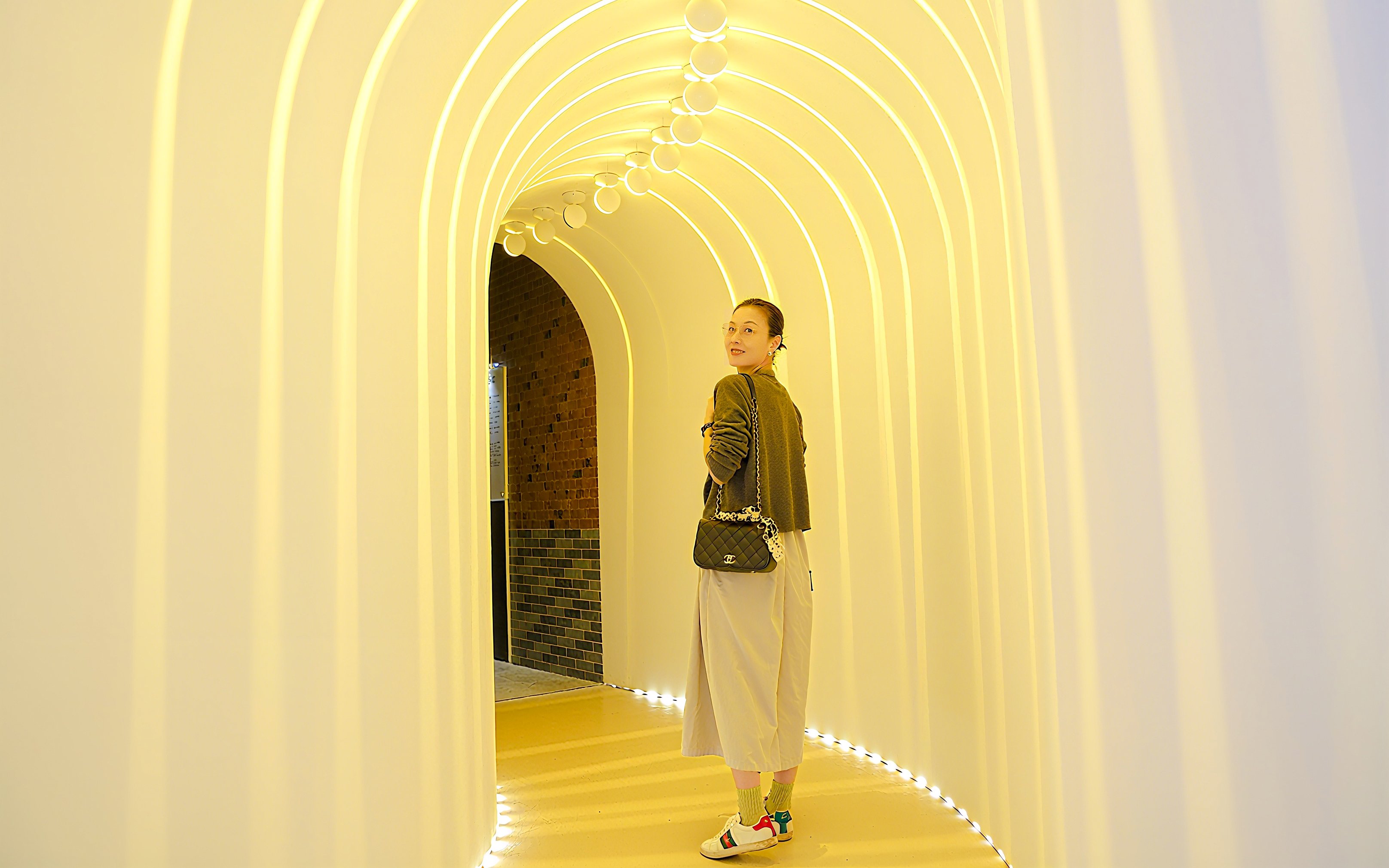 Visitor exploring illuminated tunnel at Space & Time Cube in Bangkok.
