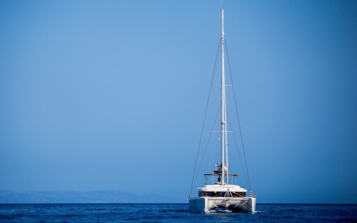 Catamaran sailing on open sea during Semi Private Comfort Day Cruise.
