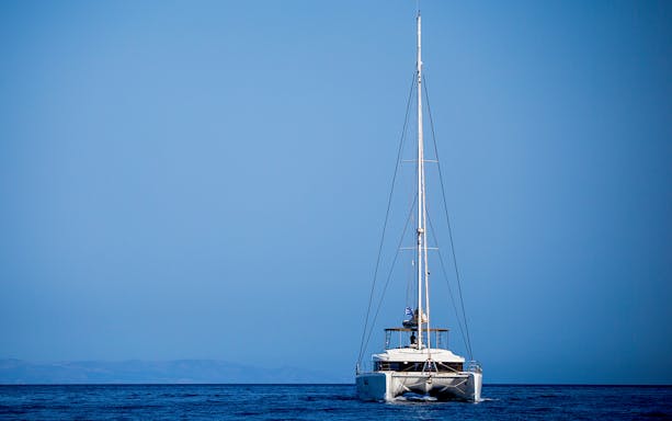 Catamaran sailing on open sea during Semi Private Comfort Day Cruise.
