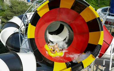 Water slide at Hurricane Harbor Chicago with people on a yellow raft.