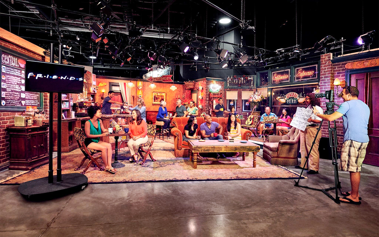 Visitors on the Friends set tour at Warner Bros. Studios Hollywood, Central Perk café scene.