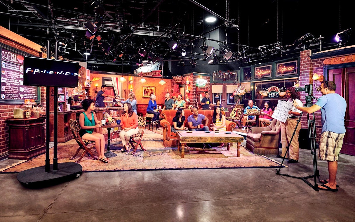 Visitors on the Friends set tour at Warner Bros. Studios Hollywood, Central Perk café scene.