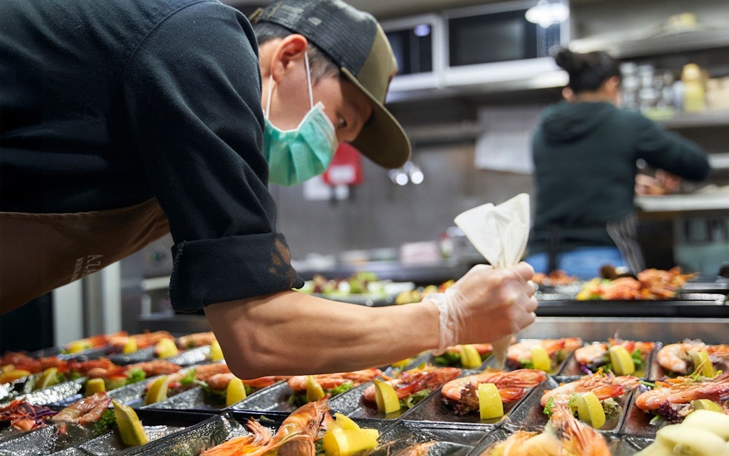 Chef preparing seafood dishes at Spirit of Melbourne Cruising Restaurant.