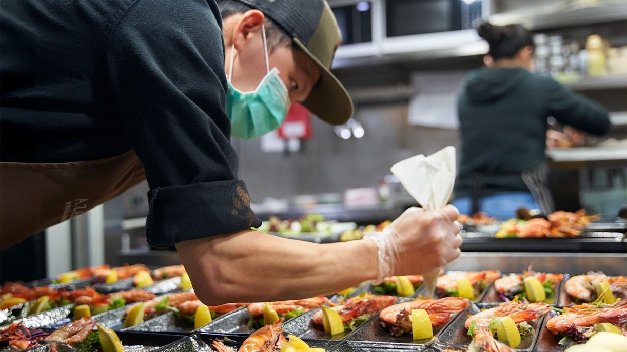 Chef preparing seafood dishes at Spirit of Melbourne Cruising Restaurant.