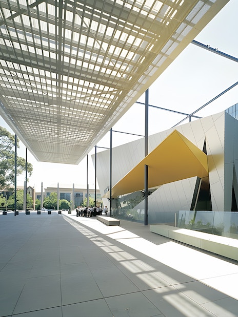 Melbourne Museum modern entrance with architectural canopy and visitors.