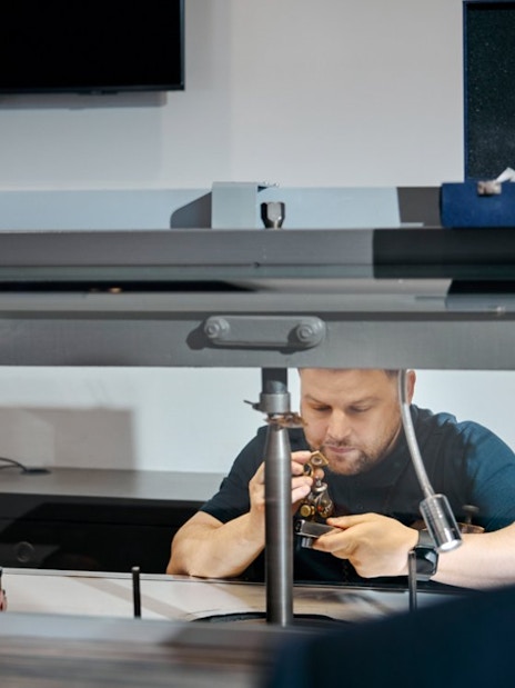 Guests watching a craftsman polishing diamonds at Royal Coster Diamond Experience, Amsterdam.