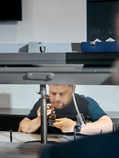 Guests watching a craftsman polishing diamonds at Royal Coster Diamond Experience, Amsterdam.