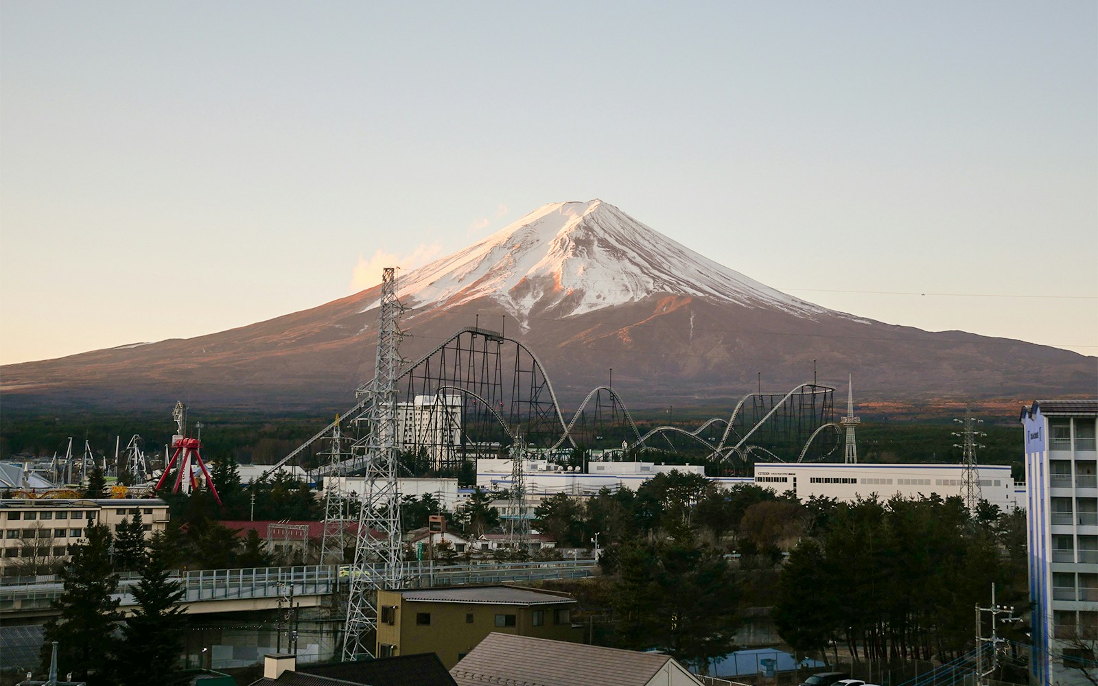 Fuji-Q Highland amusement park with Mt. Fuji in the background, Japan.