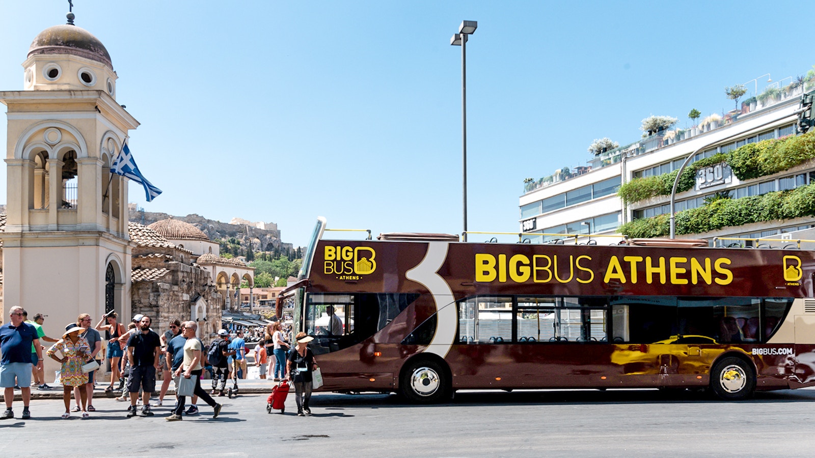 Athens Hop-on Hop-off bus tour showcasing a vibrant city view with historical landmarks and blue skies