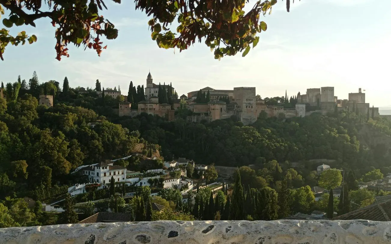 Alhambra palace and lush greenery viewed from Sacromonte, Granada.