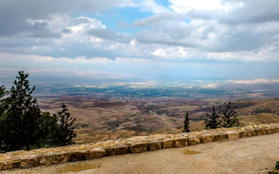 View from Mount Nebo overlooking the Jordan Valley on a cloudy day, part of the Amman full-day tour.