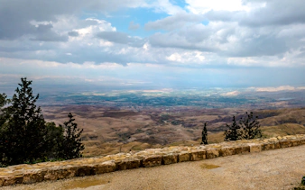View from Mount Nebo overlooking the Jordan Valley on a cloudy day, part of the Amman full-day tour.