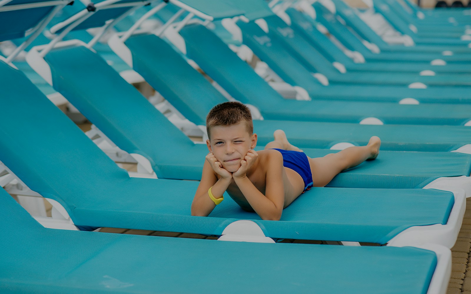 Child relaxing on a sun lounger