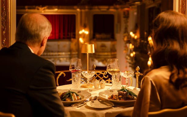 Couple dining at Mozart Dinner Opera in Prague with elegant table setting.