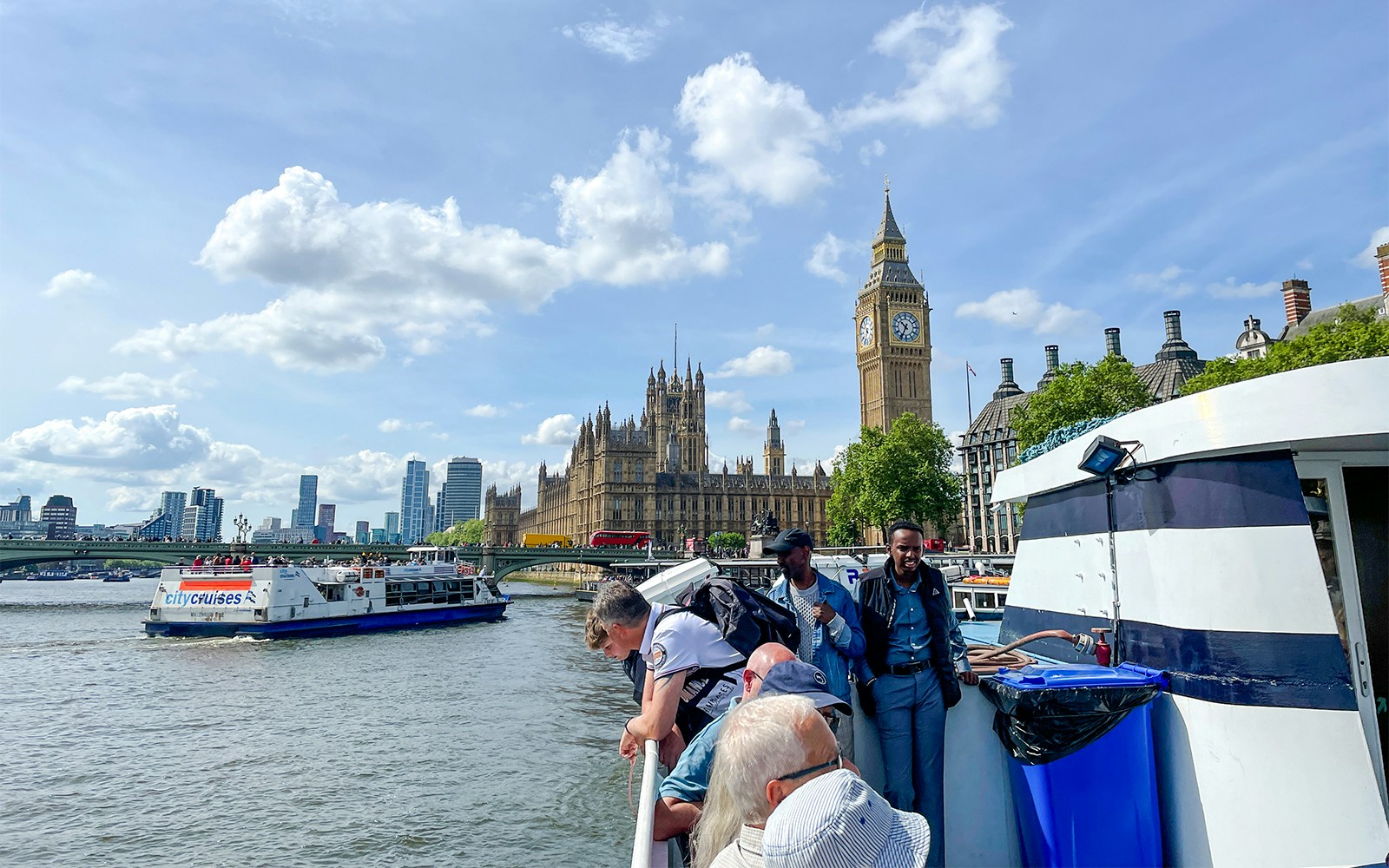 River cruise boat on the Thames passing iconic London landmarks like the London Eye and Big Ben.