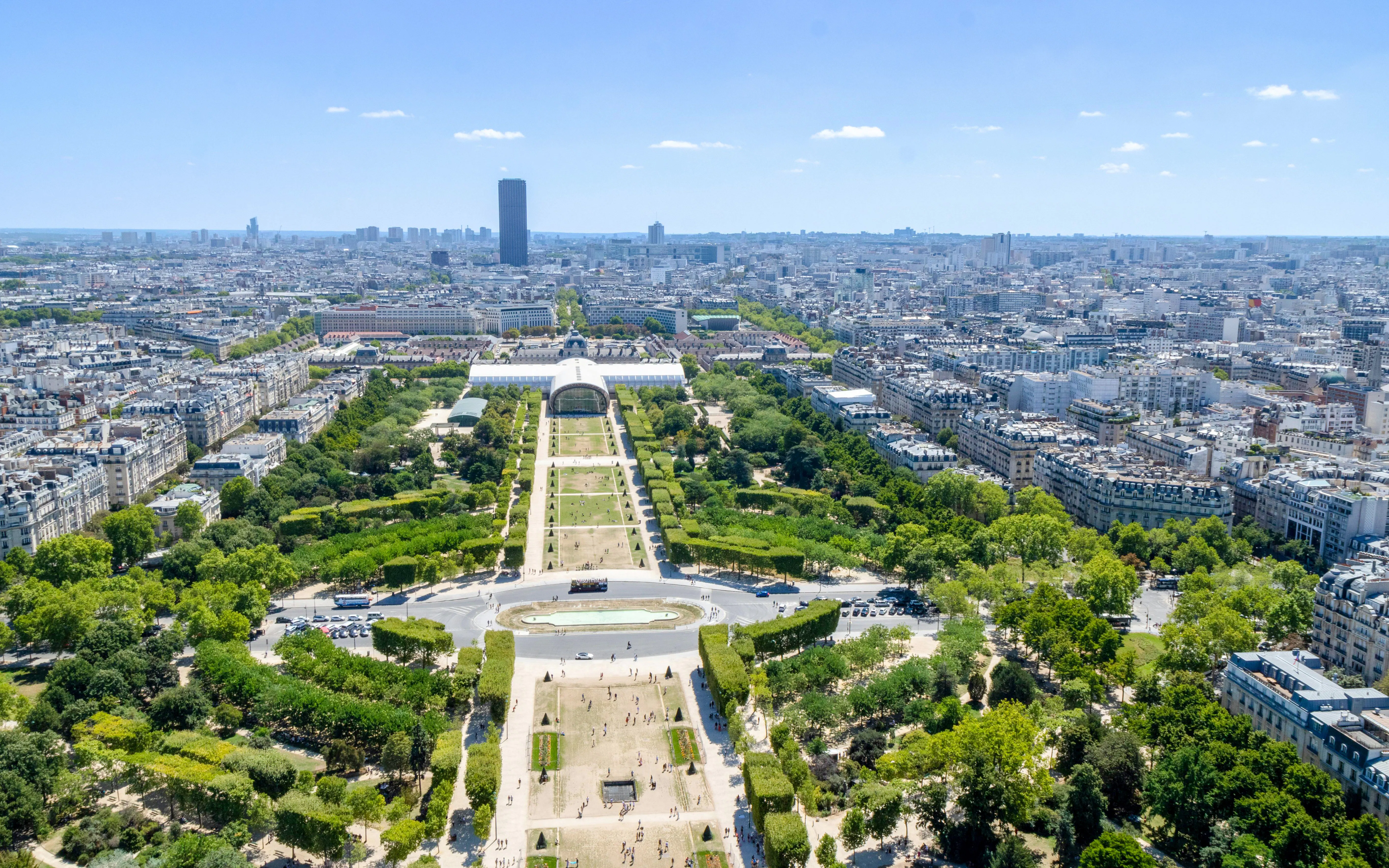 Aerial view of Champ de Mars park in Paris with cityscape in the background.