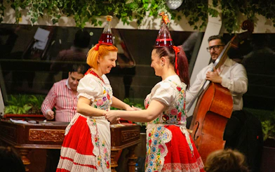 Budapest folklore dancers performing on dinner cruise with live musicians.