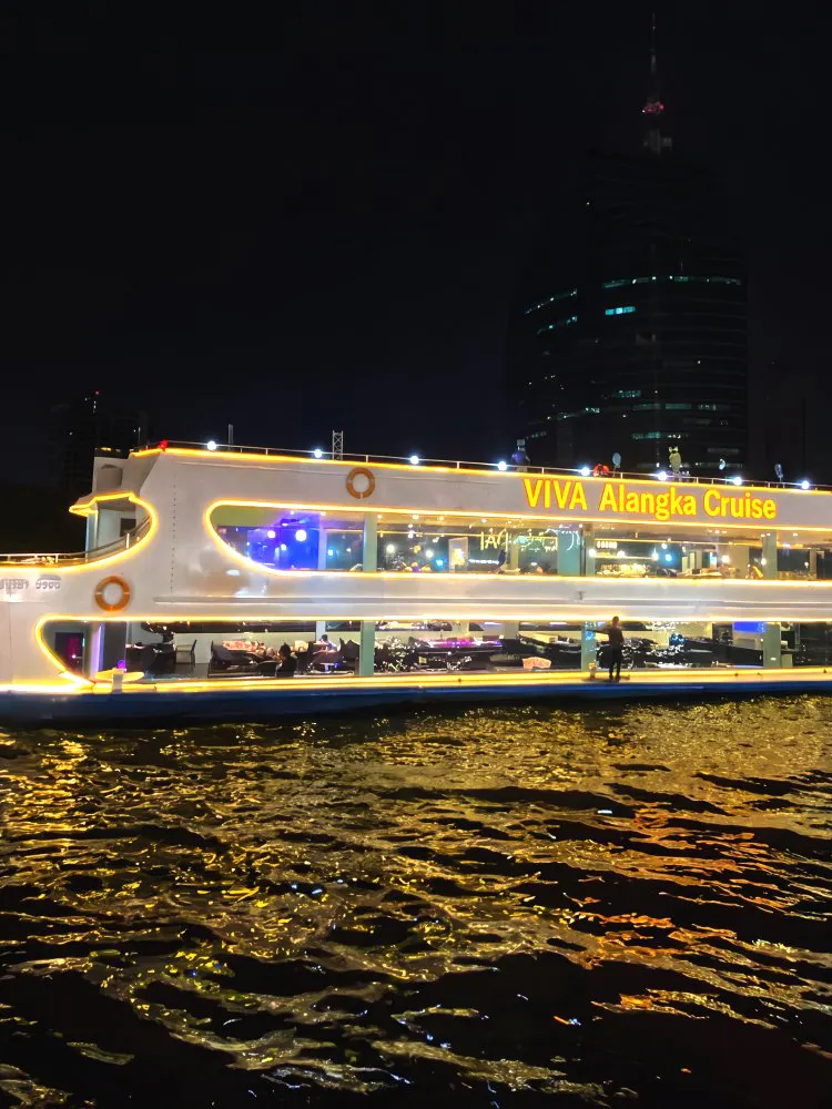 Viva Alangka Cruise illuminated on Chao Phraya River at night, Bangkok.